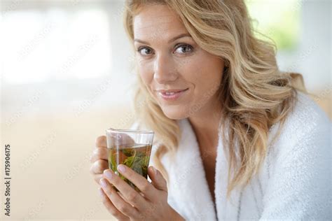Portrait Of Attractive 40 Year Old Woman In Bathrobe Drinking Infusion