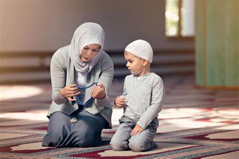 Muslim Mother Teach Her Son Praying Inside the Mosque Stock Image