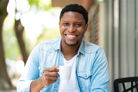 Premium Photo Young African American Man Relaxing While Drinking A
