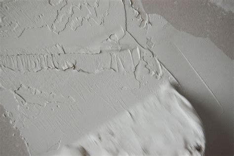 Fix damaged areas of the walls with a patching compound. Drywall 101: Using Joint Compount for a Stucco Wall Finish ...