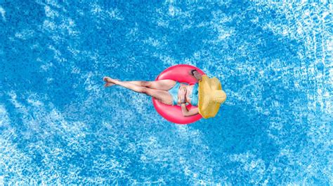 Beautiful Young Woman In Hat In Swimming Pool Aerial Top View From