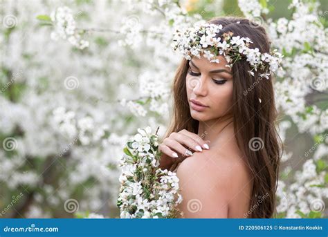 Sensual Nude Woman With Wreath And Cherry Branches Enjoys The Summer Blooming Nature Stock Image