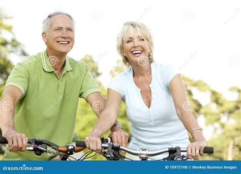Mature Couple Riding Bikes Stock Photo Image Of Countryside