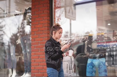 Beautiful Girl Using Mobile Phone While Having Coffee Outside The Mall — Wireless Technology