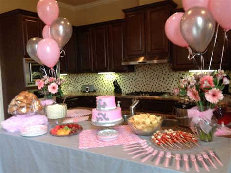 A Table Topped With Lots Of Pink And Silver Balloons Next To A Counter