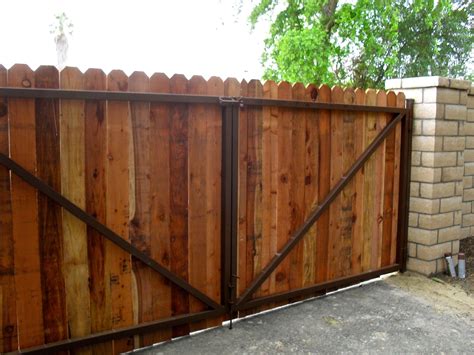 a wooden fence with an iron gate