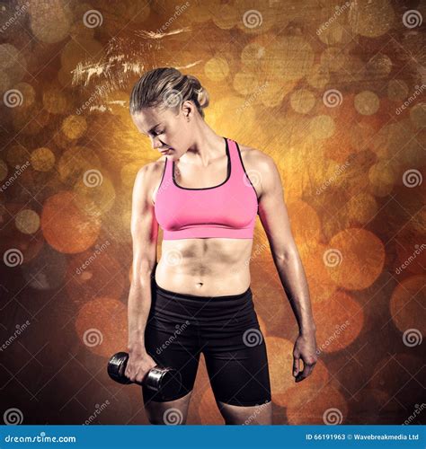 Composite Image Of Muscular Woman Lifting Heavy Dumbbell Stock Image