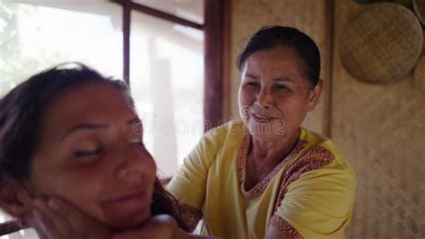 thai elder masseuse doing hand massage on hispanic woman side view stock video video of