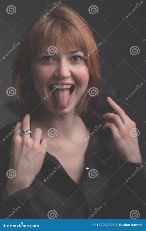 Portrait Of A Redhead Girl Who Playing The Fool And Shows Tongue