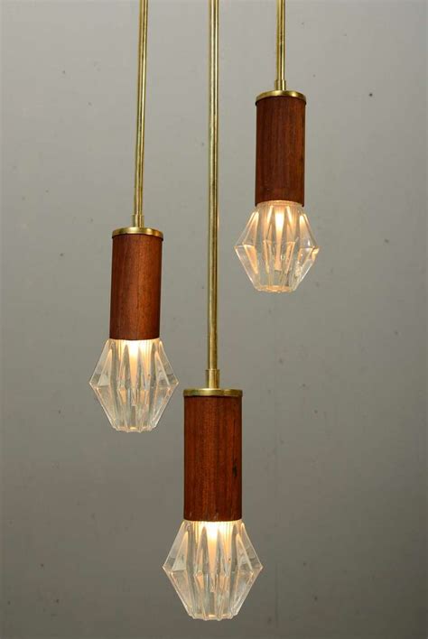 The previous owner put in some nice 80's can lights in each section. Pair Hanging Mid Century Light Fixtures at 1stdibs
