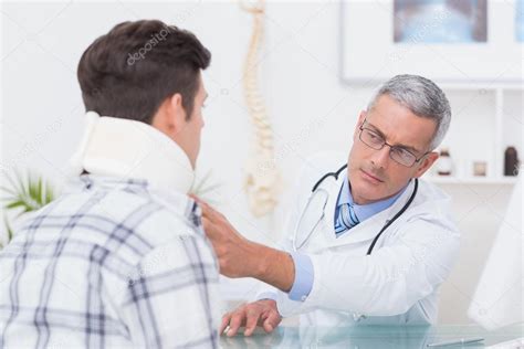 Doctor Examining Patient Wearing Neck Brace Stock Photo By