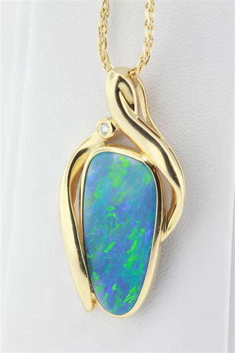 Boulder Opal Set In Yellow Gold With A Dew Drop Diamond Boulder Opal