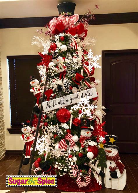 A Christmas Tree Decorated With Red And White Ornaments