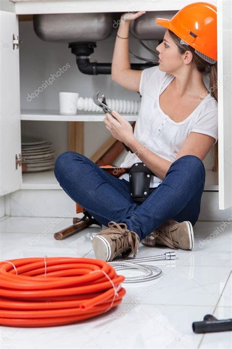 Female Plumber Fixing The Pipe Stock Photo By Implementar 86708656