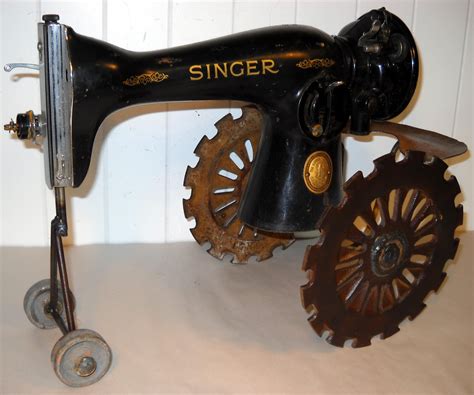 vintage cast iron singer sewing machine tractor with metal drain piece front wheels and roller