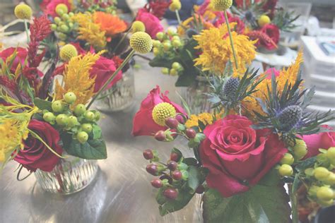 Putting dried flowers in a jar. The Hourglass: DIY Mason Jar Floral Arrangements