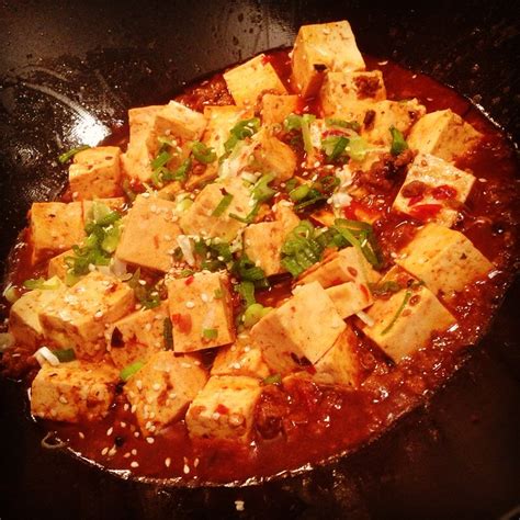During the boiling of soy milk, in an open shallow pan, a film or skin forms on the liquid surface. Ma Po Tofu