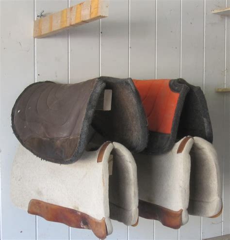 Hook the j hook of your saddle rack into the eye hook so your saddle rack is perpendicular to the wall mount. DIY Saddle Racks | NickerNews