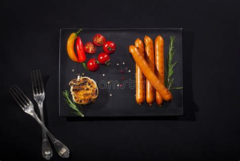 Wiener Sausages In A Dish On Black Background Top View With Copy Space