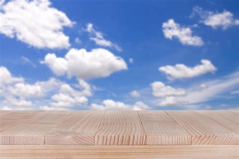 Premium Photo Brown Wood Table Top On Bokeh Abstract Blue Sky