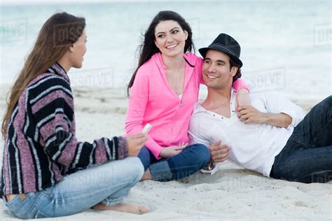 Friends Relaxing Together On Beach Stock Photo Dissolve
