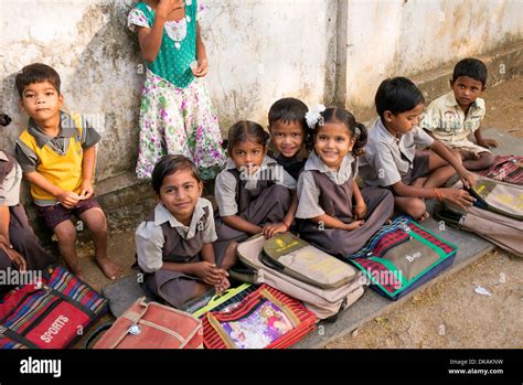 Rural Indian Village School Children Sitting By A Wall In An Outside