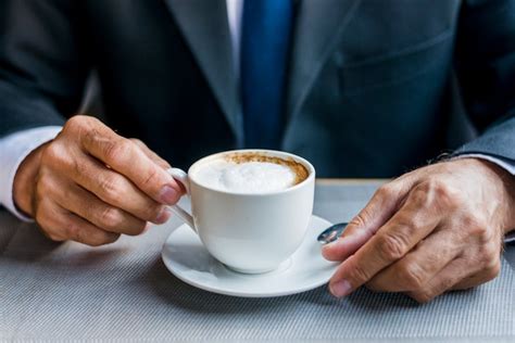 Free Photo Close Up Of A Businessmans Hand Holding Cup Of Coffee