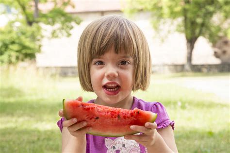 Portrait Of Little Girl Eating Watermelon Stock Photo