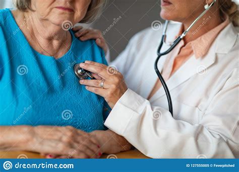 Female Doctor Checking The Heart With Stethoscope Of Senior Adult Woman Stock Image Image Of