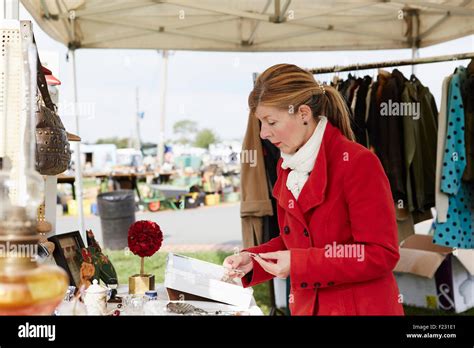 A mature woman bargain hunter browsing through vintage jewellery items