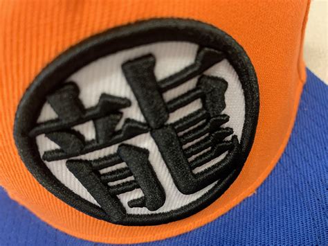 Cancer constellation has 2 planets that orbiting its (own) a star other than the sun. What does this symbol on my hat mean : dbz