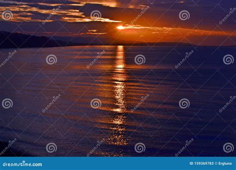 A Breathtaking Sunset Paints The Sky And Ocean In Vibrant Hues At