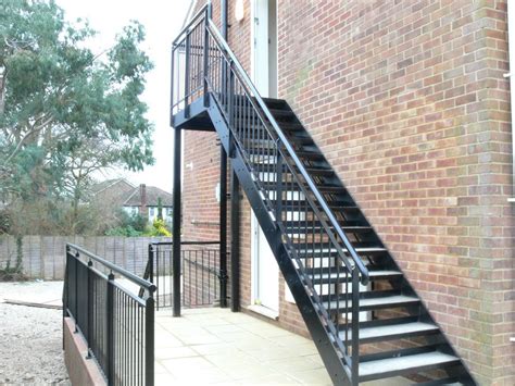 Metal stairs and landing outside a private house for access. Steel Staircases | Exterior stairs, Outdoor stairs, Staircase outdoor
