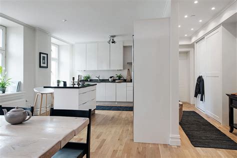 Heating a neutral black kitchen with an attractive yellow accent is always a good idea. Black And White Themed Scandinavian Apartment With Modern ...