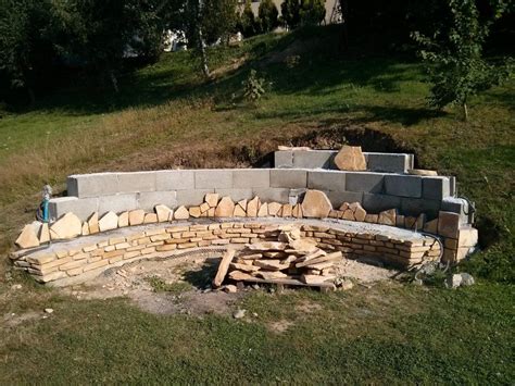 Use a shovel to outline the perimeter and then remove the blocks. They Built A Fireplace Into Their Sloping Hillside - The ...