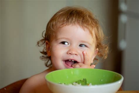 Healthy Nutrition For Kids Funny Baby Eating Food Himself With A Spoon