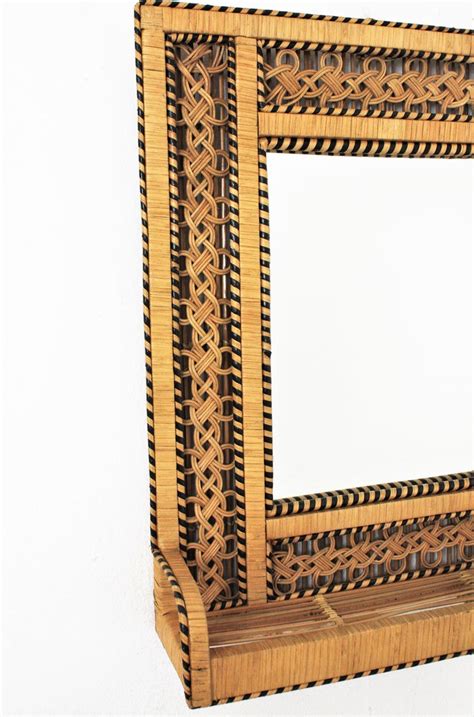 The craftsmanship and design of this wall mirror requires skilled artisans to create the intricately coiled natural rattan around this rectangular mirror. Spanish Woven Wicker and Rattan Mirror Shelf with Filigree ...