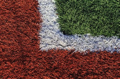 Football Fieldgreen And Red Soccer Field In Sunny Day Stock Photo