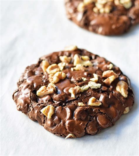 Two Chocolate Cookies With Nuts On Top
