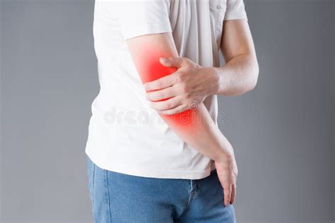 Man Suffering From Pain In Elbow Joint Inflammation Stock Photo