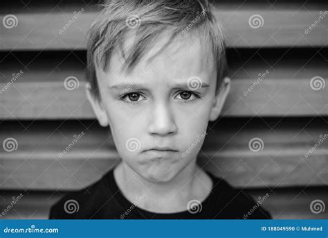 Portrait Of Upset Gloomy Boy Kid With Pessimistic Depressive Emotions
