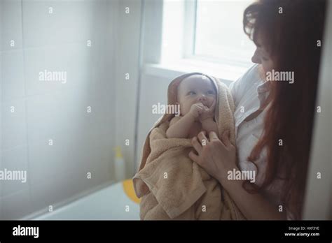 Mother Drying Baby Off With Towel In Bathroom Stock Photo Alamy