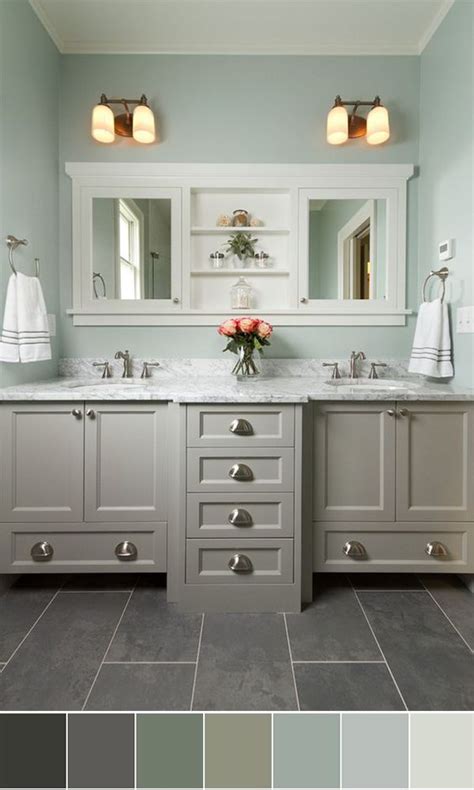 A Bathroom With Two Sinks And White Cabinets