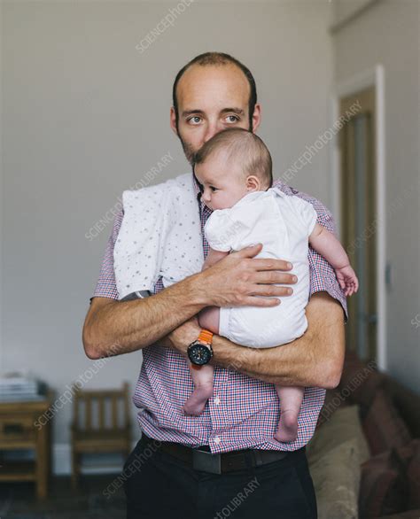 A Man Holding A Young Baby Close Stock Image F0128735 Science