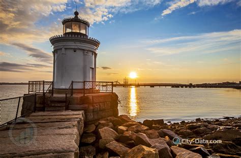 It lives on a tiny rock island and is made of gray granite blocks. Bug light lighthouse in portland maine at sunrise