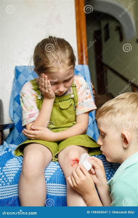 Little Girl Hurt Her Knee A Boy Heals Her Wound Stock Image Image Of