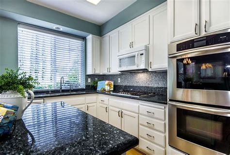 I have already cut and fit the counters and in this video i'm using silicone to glue the pieces to the plywood. kitchens blue pearl granite countertops - Google Search ...