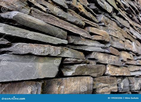 The Stone Wall Made Of Slate Bricks Which Is Very Rough Material Stock