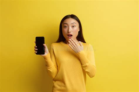 Surprised Woman Holding Smartphone Shocked Girl Standing And Holding