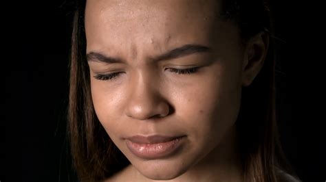 Close Up Of Young African Woman Face Crying And Then Looking At Camera